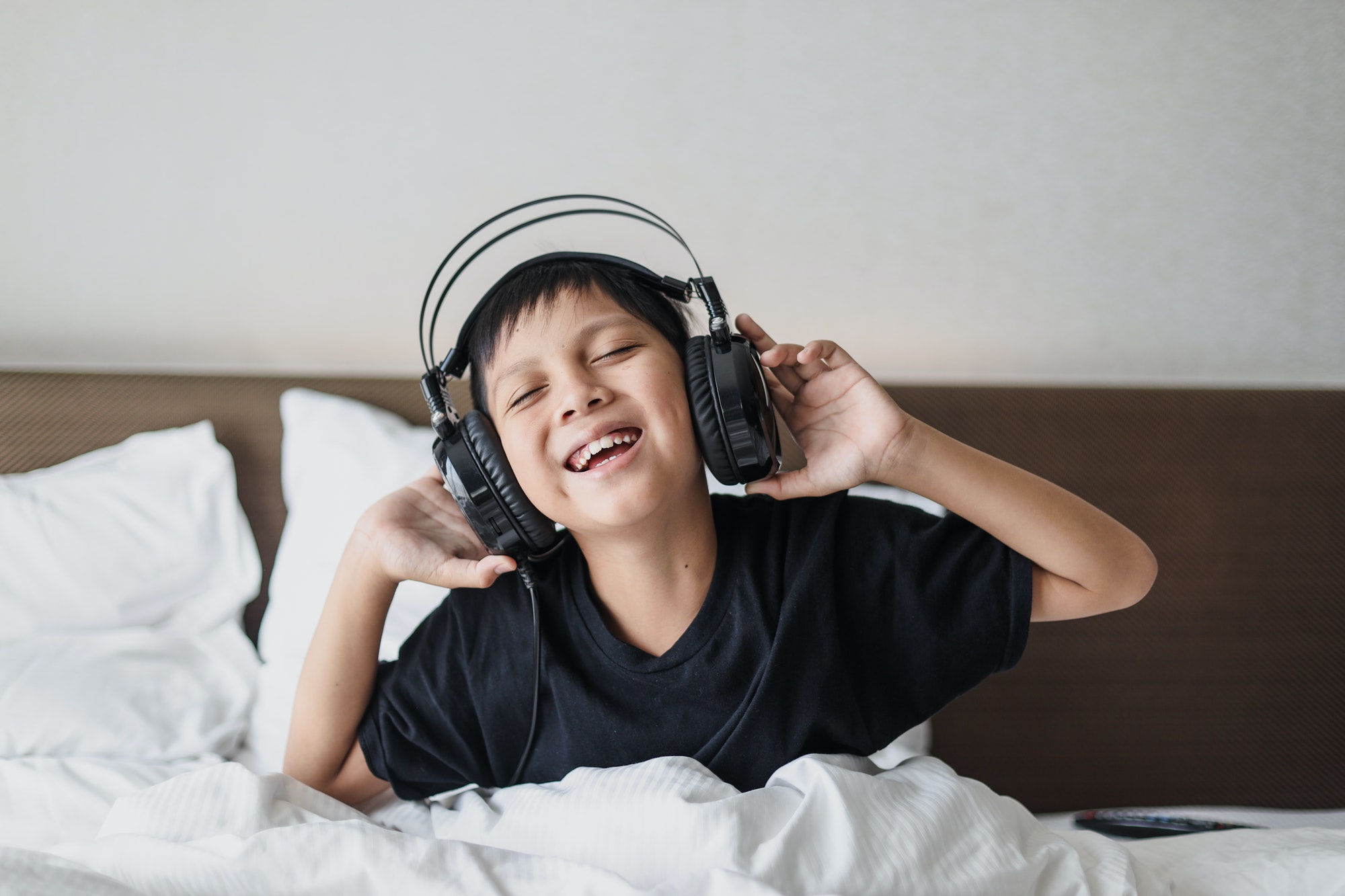 Happy boy listening music on headphone