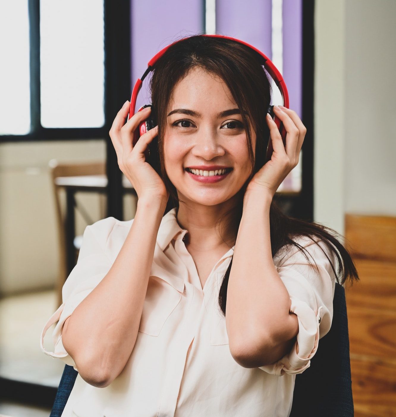 Portrait cheerful young woman listening music with headphones.