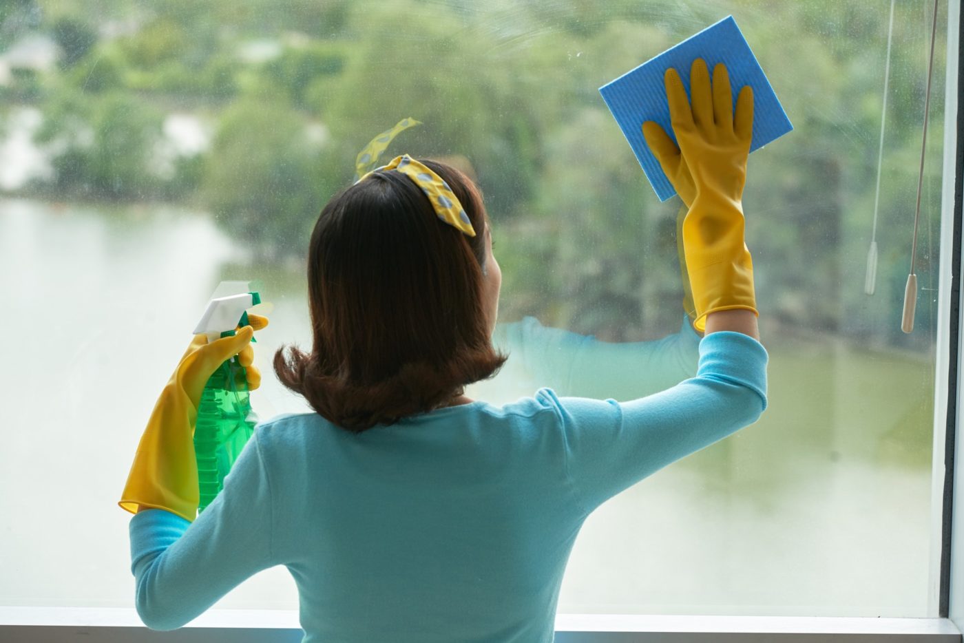Housekeeper Cleaning Panoramic Window