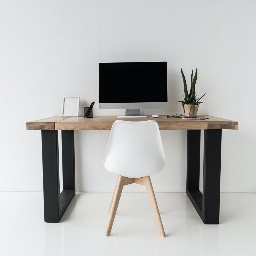 workplace with computer and stylish furniture in modern office