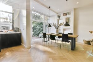 Delightful dining area with two hanging lamps above the table