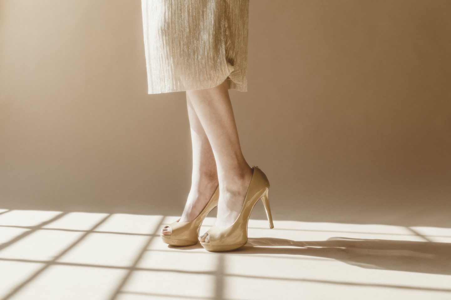 Fashionable woman wearing creamy heels