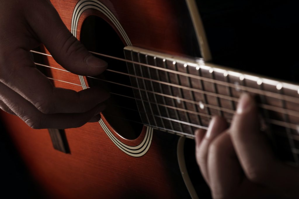 Musician playing on guitar