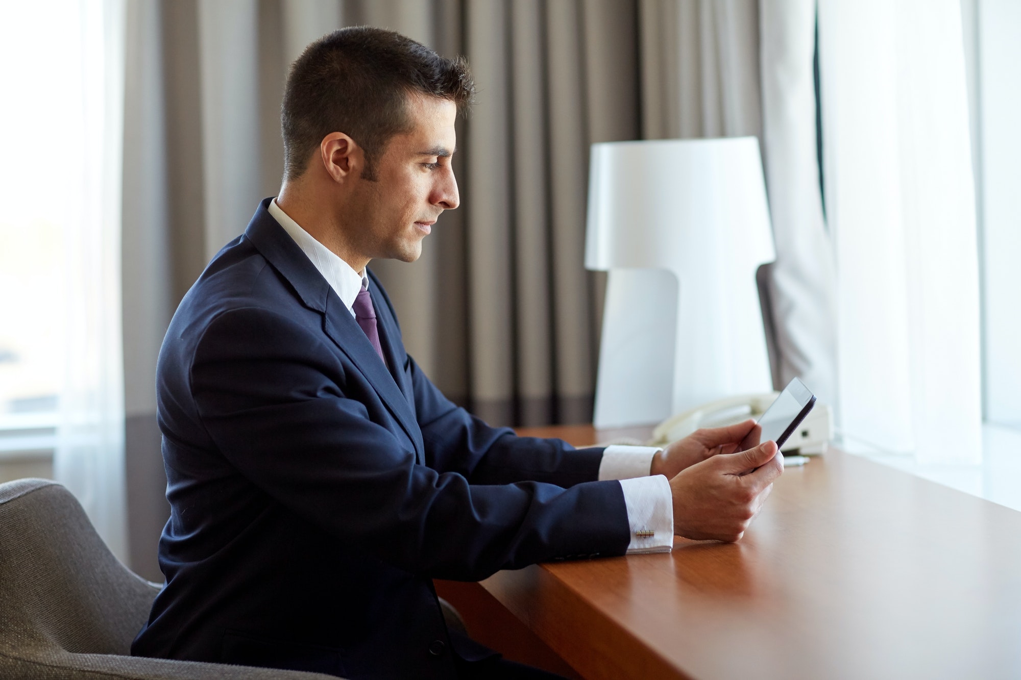 businessman with tablet pc working at hotel room
