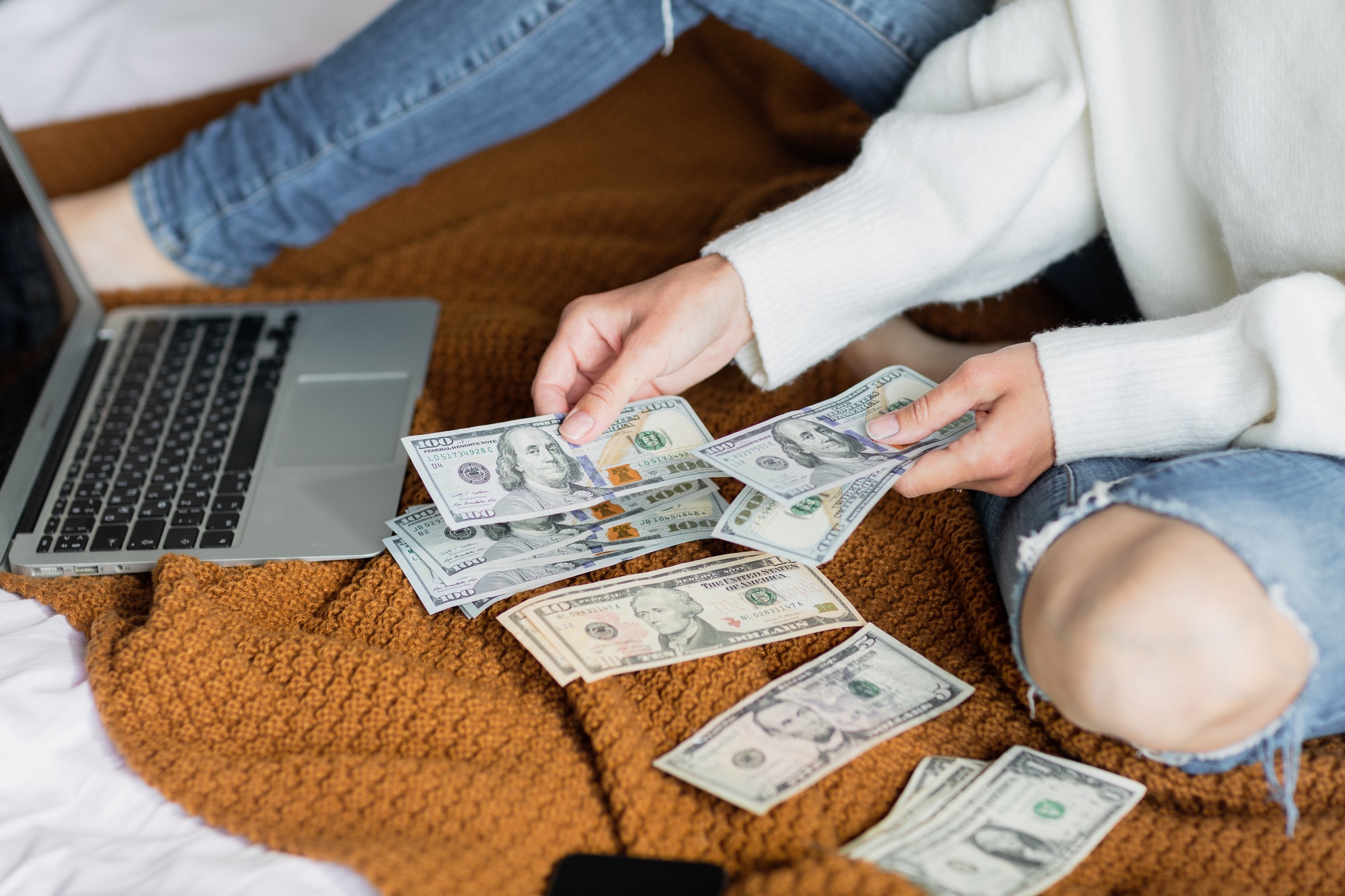 Woman counting cash money for Christmas gifts