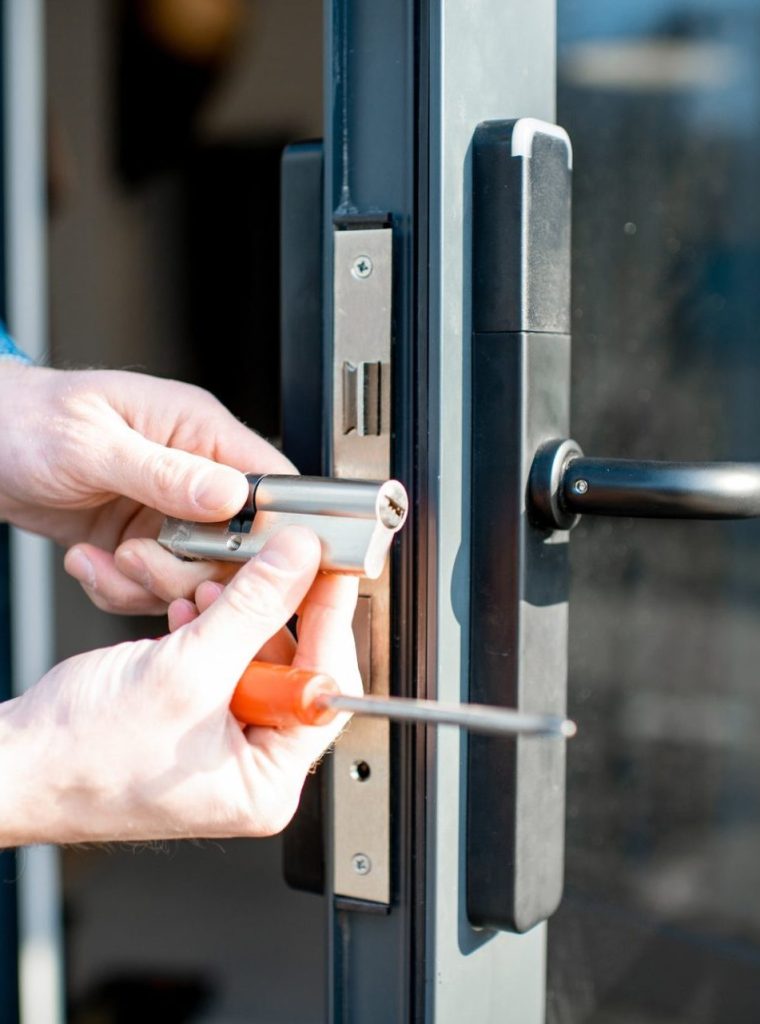 Man changing core of a door lock