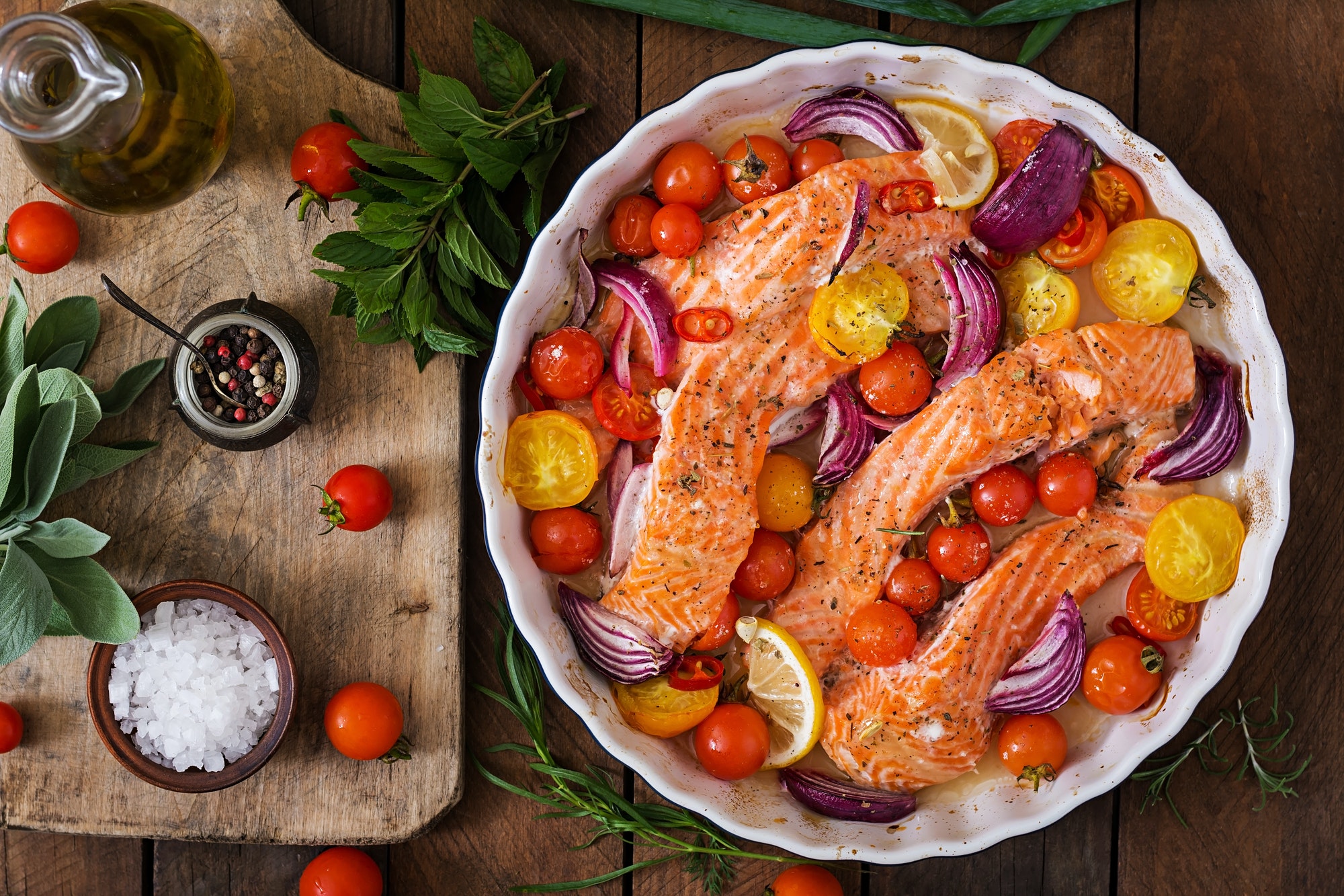 Baked salmon fillet with tomatoes, red onions and spices. Diet menu.