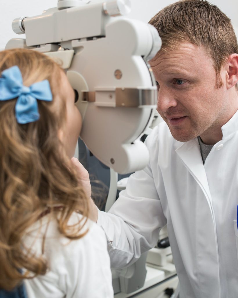 Optician testing a girl's eyes