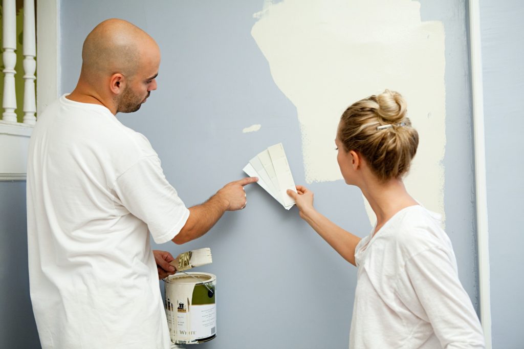 Couple painting wall