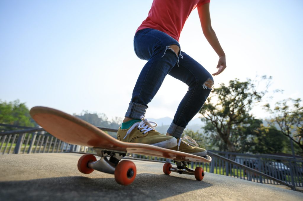 Woman skateboarder skateboarding at skatepark