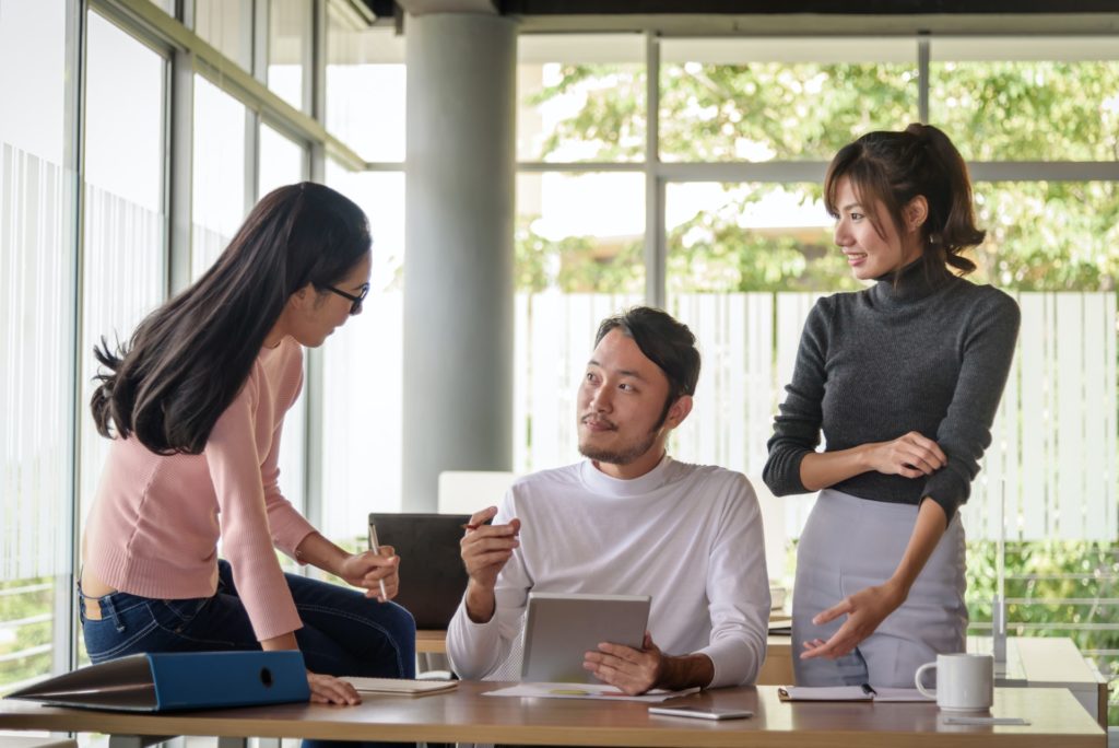 young asian businessman working with team in startup office