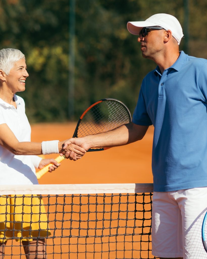 Tennis Instructor with Senior Woman