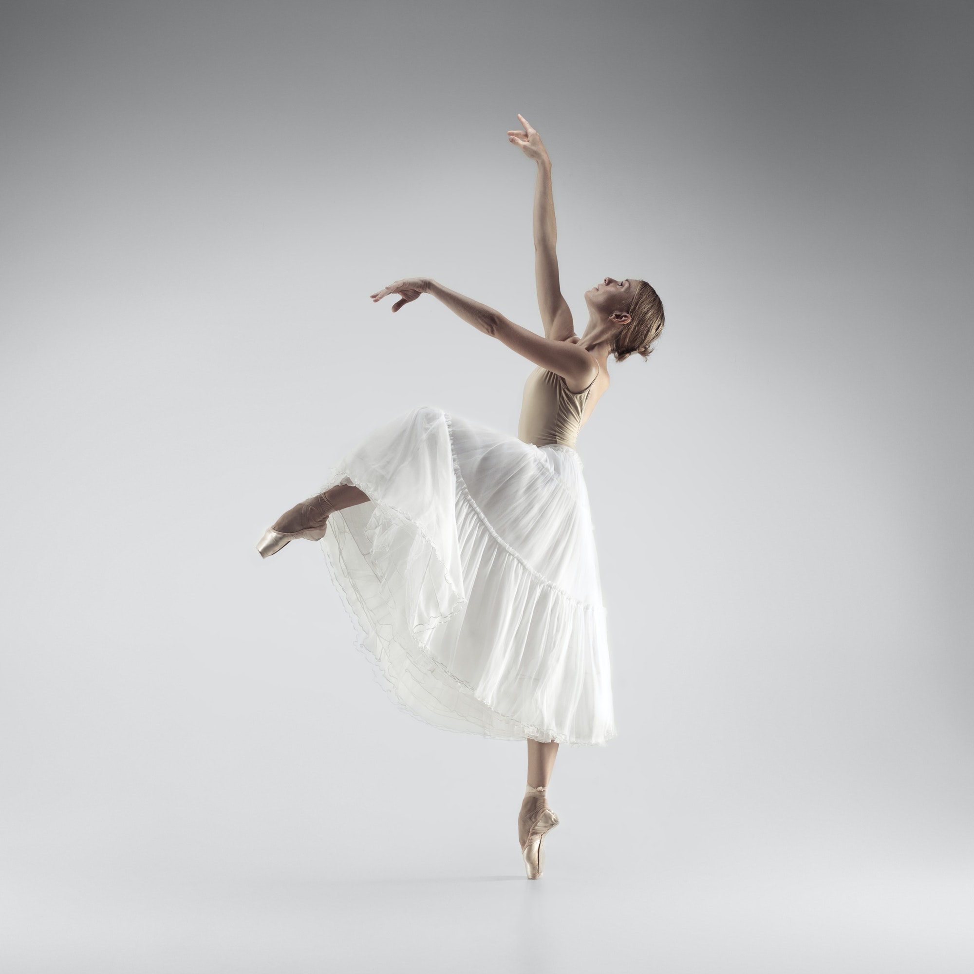 Ballerina. Young graceful female ballet dancer dancing at studio. Beauty of classic ballet.